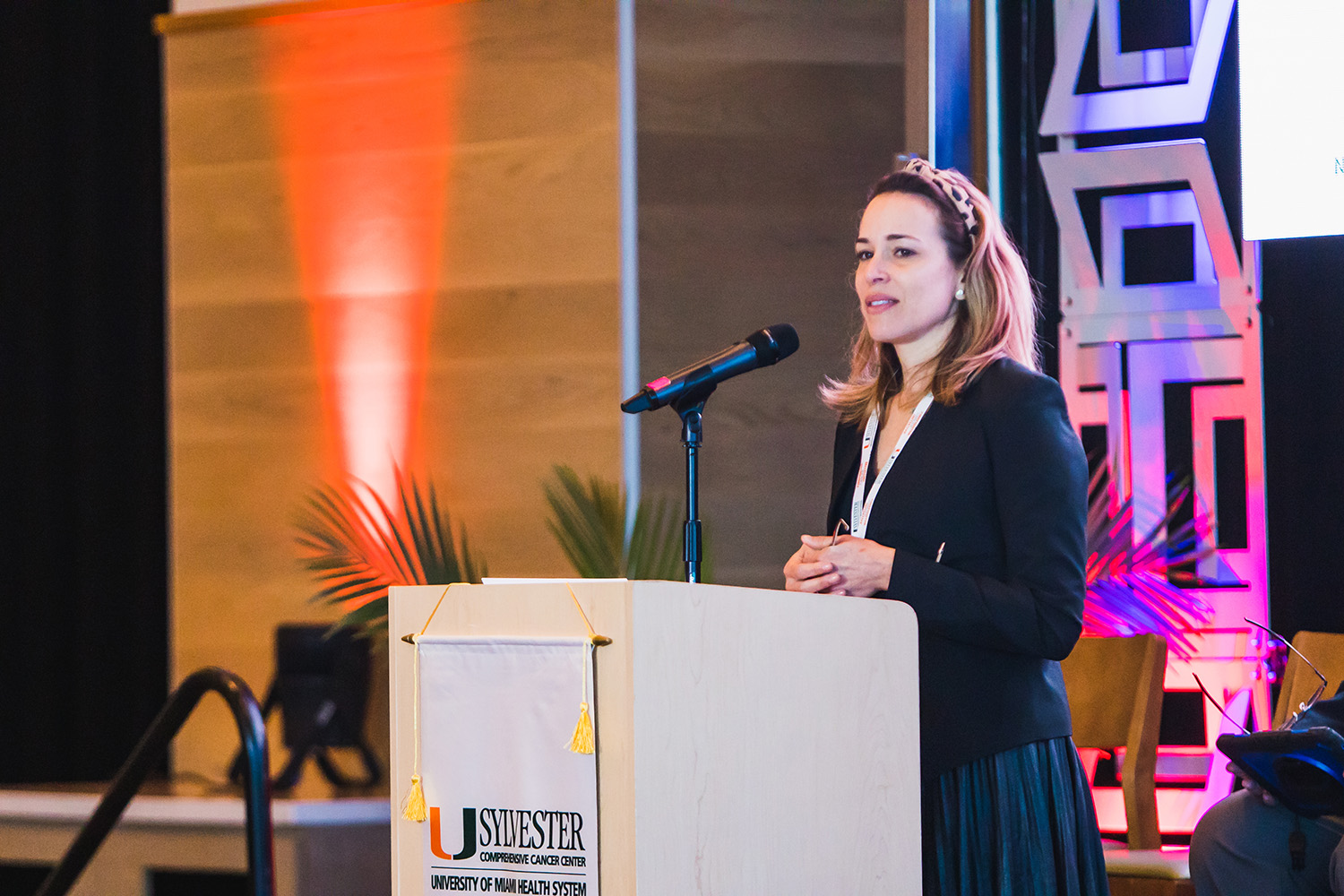 A woman speaks at a podium at the National Firefighter Symposium