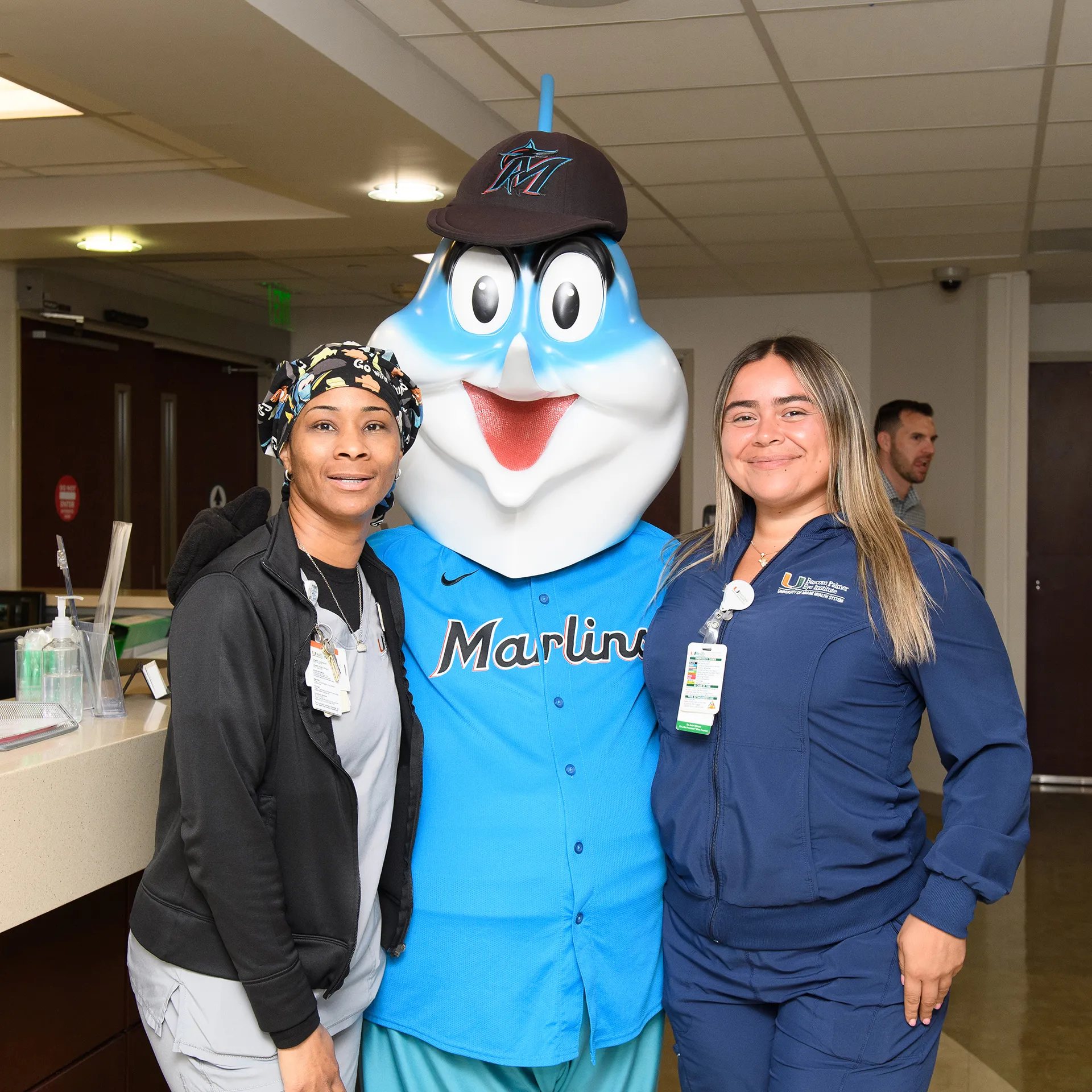 Billy the marlin poses with two nurses at UHealth