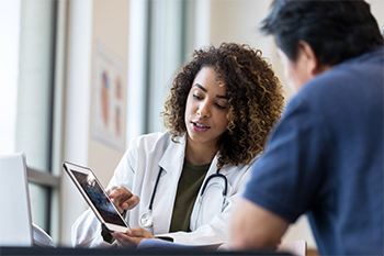 Woman doctor talking to a male patient